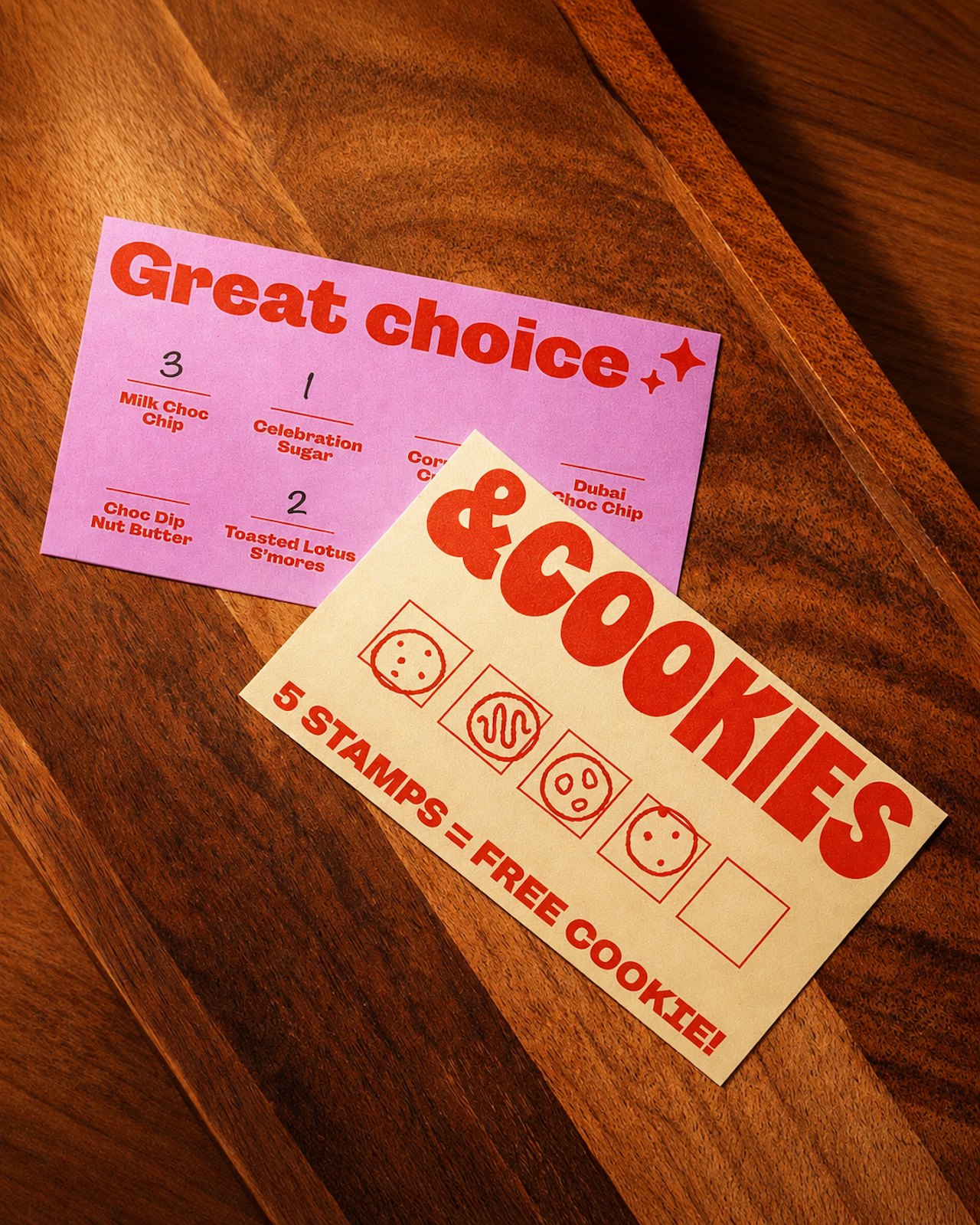 &Cookies printed menu and takeaway packaging on a wooden table