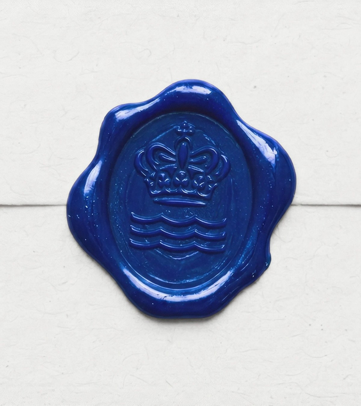 Blue wax seal carrying Royal Copenhagen crown and wave mark