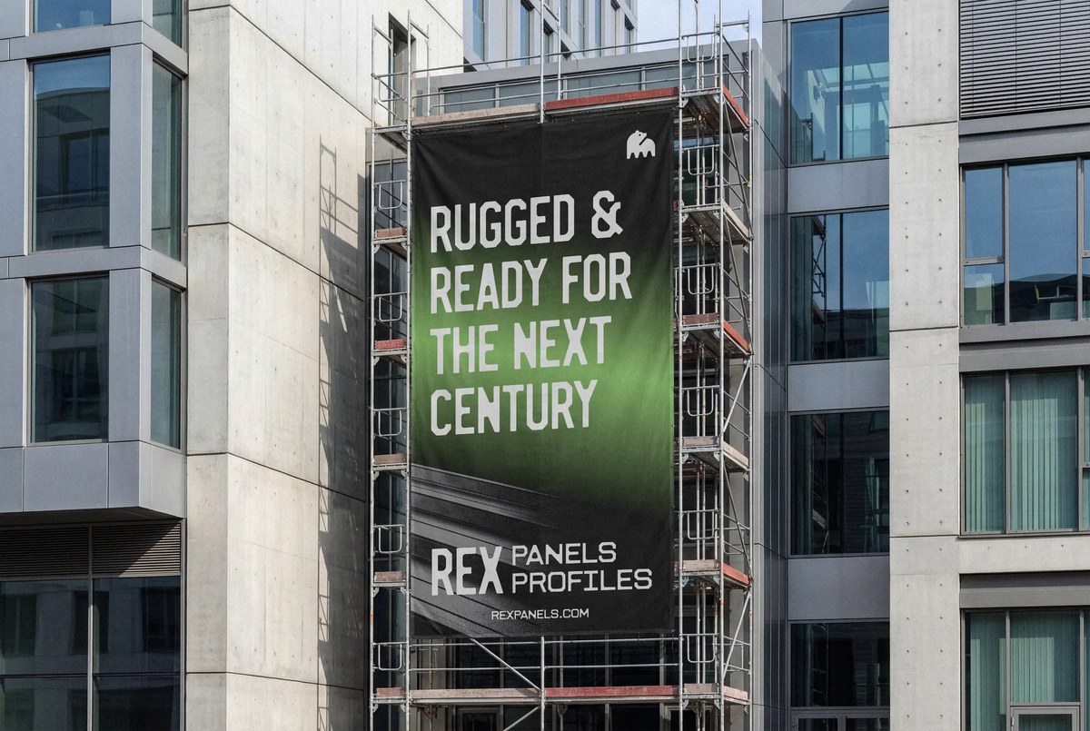 REX brand lettering and bear symbol used on building signage